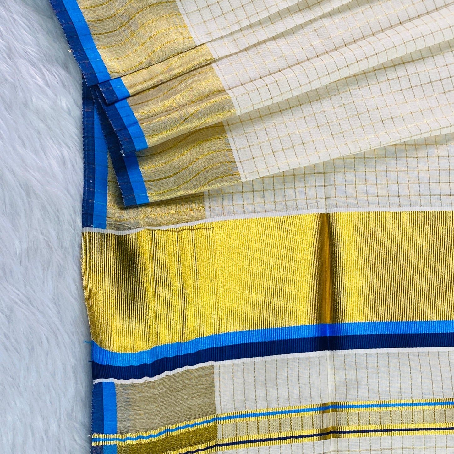 Revathi Checkered Kerala Kasavu Saree with Golden & Blue Border with Tassels