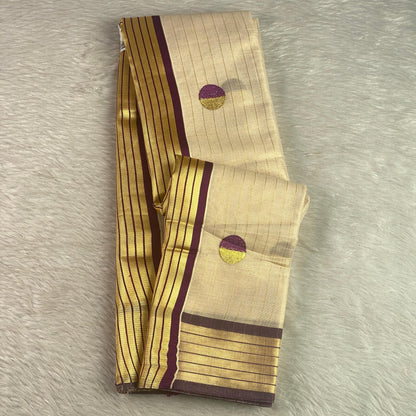 Shobana Uthradam Tissue Kerala Saree with Golden Lines and Butta work Purple