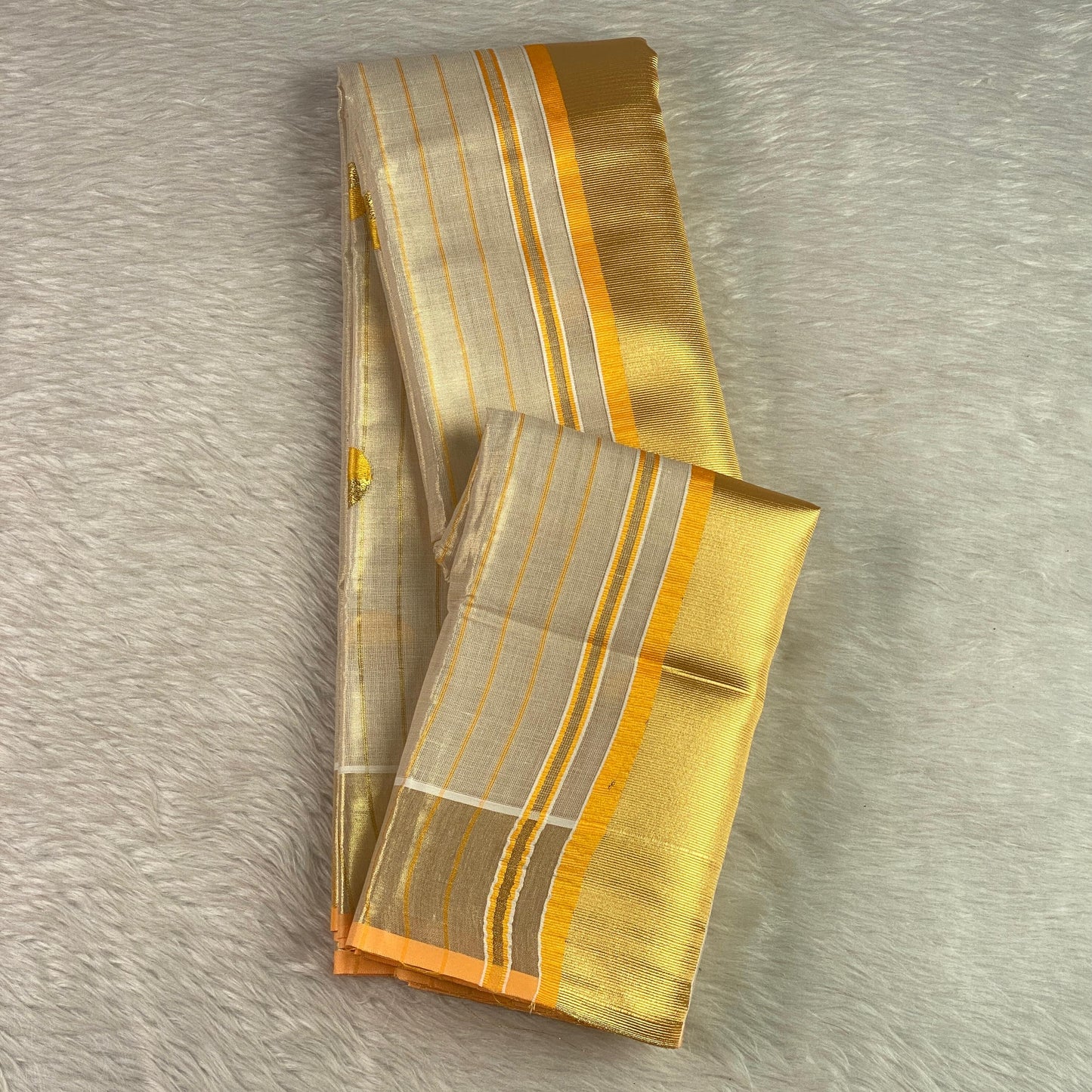 Shobana Uthradam Tissue Kerala Saree with Golden Lines and Butta work Yellow